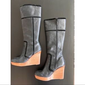 Black leather knee high boots.